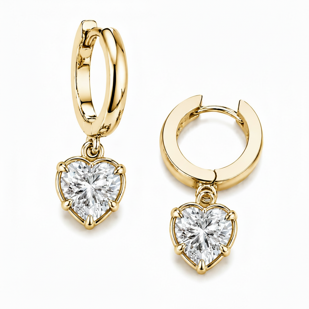 Gold hoop earrings with heart-shaped diamond pendants on a white background