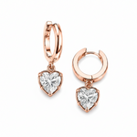 Rose gold hoop earrings with heart-shaped diamond pendants on a white background