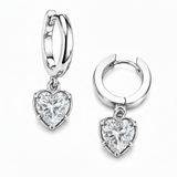 Silver hoop earrings with heart-shaped diamond pendants on a white background