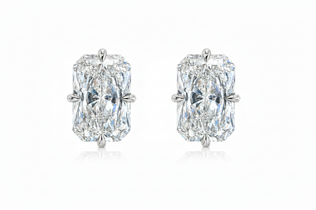 Pair of diamond earrings with rose gold settings on a white background